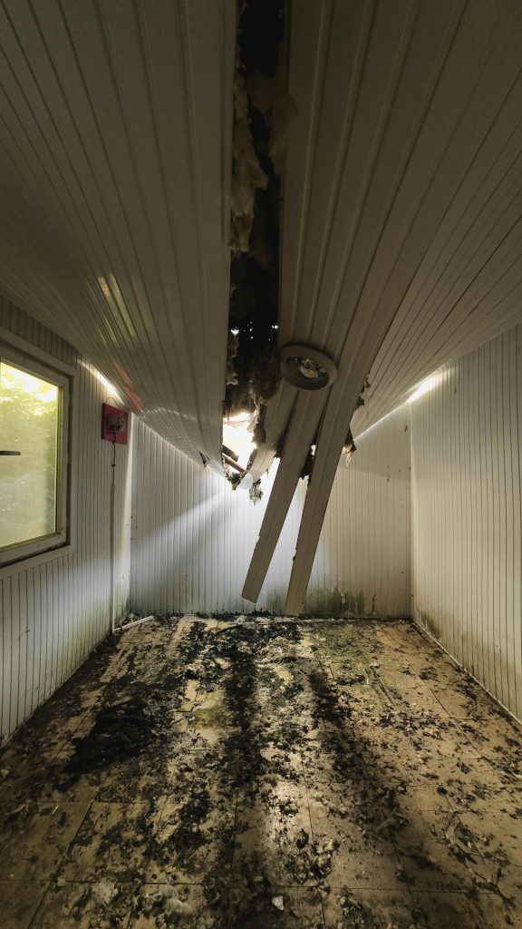 pexels-photo-30499666-30499666 Interior of a room with a collapsed ceiling showing damage and debris.